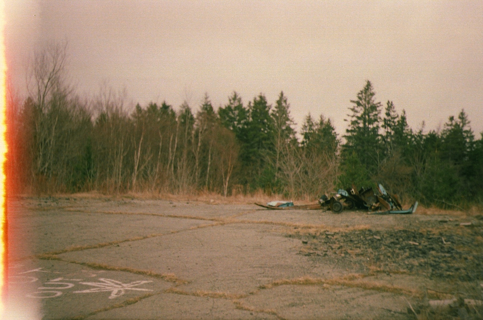 photo of an old road and a dead car